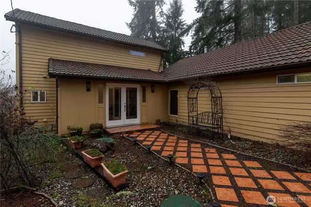 a view of a hallway with wooden floor and chandelier