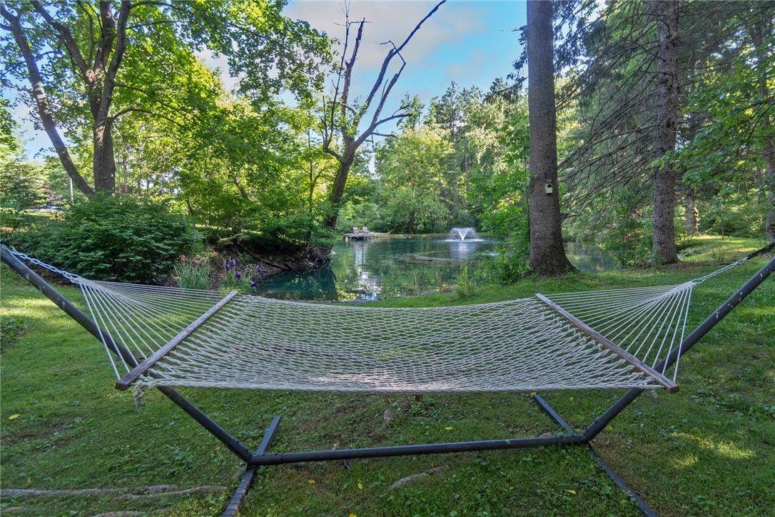 1325 Granger Road Northampton, PA 18067 - Photo 9 of 61 A tranquil oasis awaits, complete with a private pond and a bubbling fountain, framed by trees and a peaceful hammock.