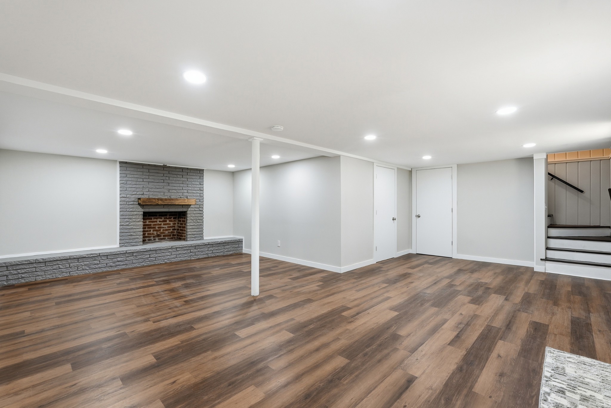 558 Walton Ferry Road Hendersonville, TN 37075 - Photo 15 of 28 an empty room with wooden floor and fireplace