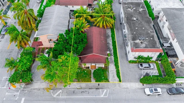 an aerial view of a house with a yard and potted plants