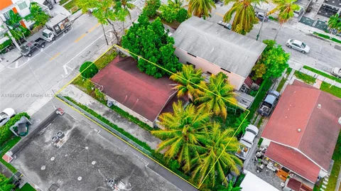 an aerial view of a house with a yard and a garden