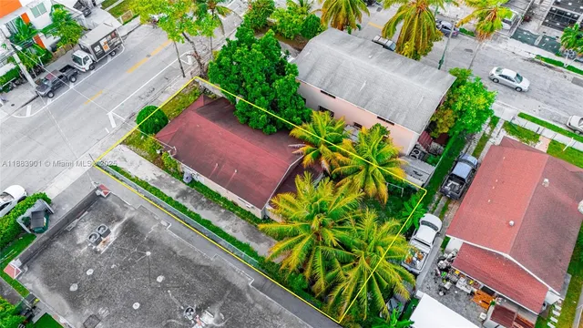 an aerial view of a house with a yard and a garden