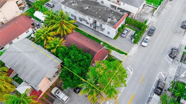 an aerial view of a house with a yard and garden