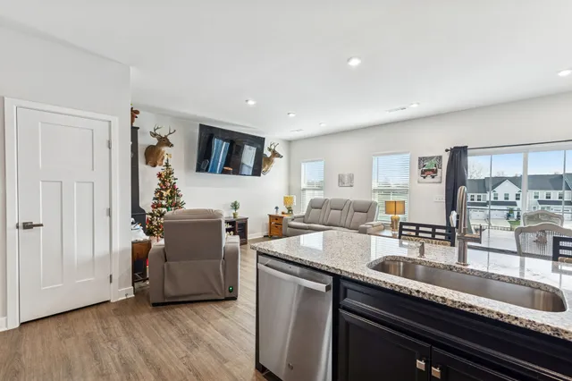 a kitchen that has a sink and a stove top oven