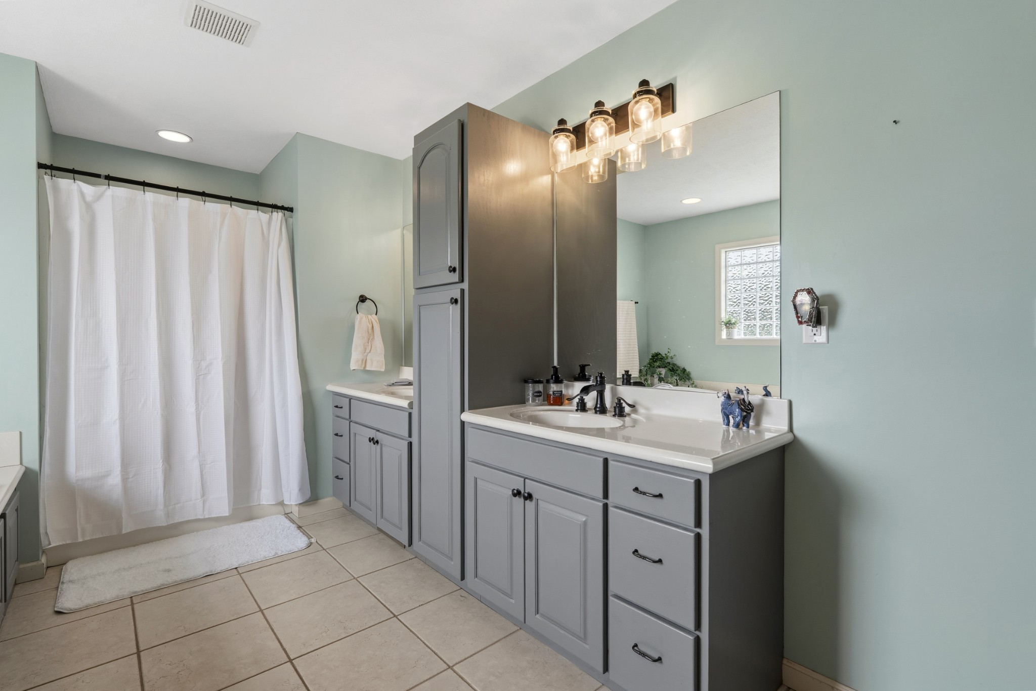 6052 Morganton Road Greenback, TN 37742 - Photo 19 of 54 a spacious bathroom with a double vanity sink and mirror