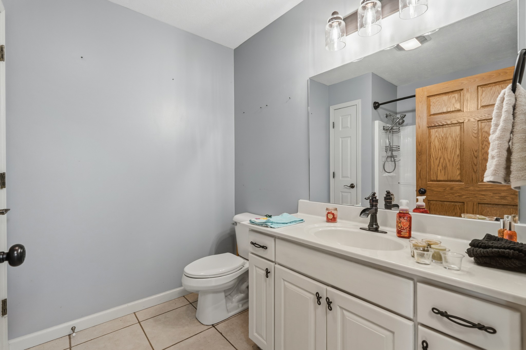 6052 Morganton Road Greenback, TN 37742 - Photo 22 of 54 a bathroom with a granite countertop sink a toilet and a mirror