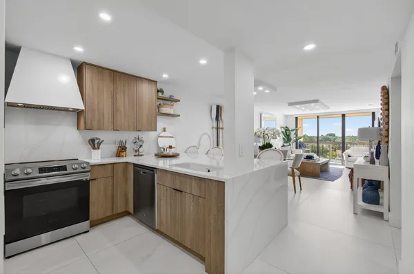 a kitchen with a sink and stove top oven