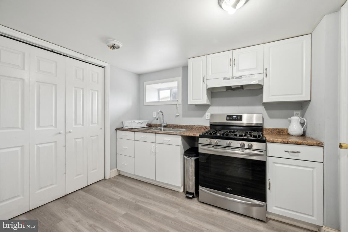 717 Bem Street Riverside, NJ 08075 - Photo 20 of 27 a kitchen with cabinets appliances and wooden floor