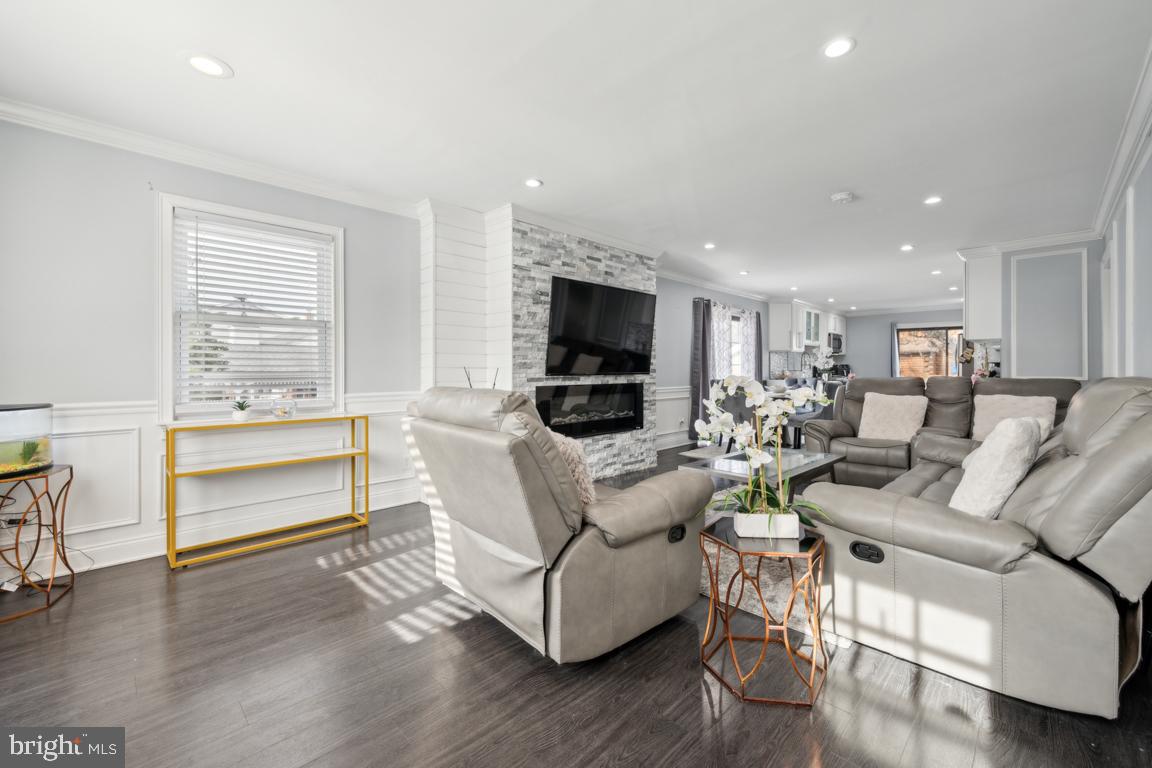 717 Bem Street Riverside, NJ 08075 - Photo 4 of 27 a living room with furniture a flat screen tv and kitchen view
