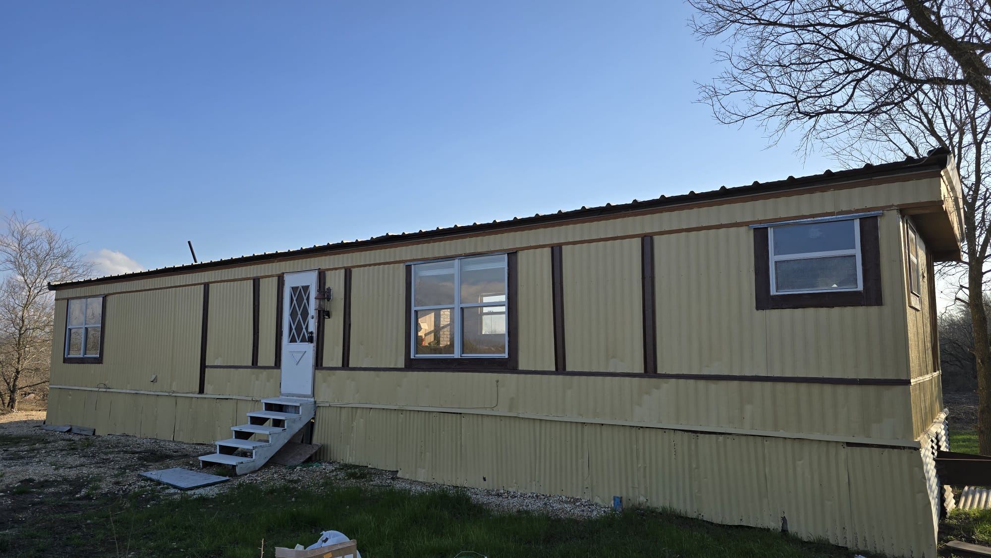 18509 Blake Manor Road Manor, TX 78653 - Photo 1 of 1 View of front of home with entry steps and a metal roof