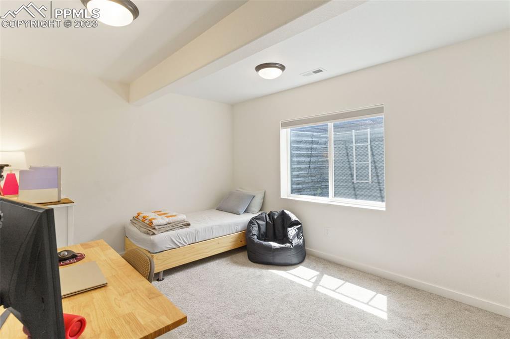 11969 Alydar Loop Colorado Springs, CO 80921 - Photo 23 of 44 a bedroom with furniture and a window