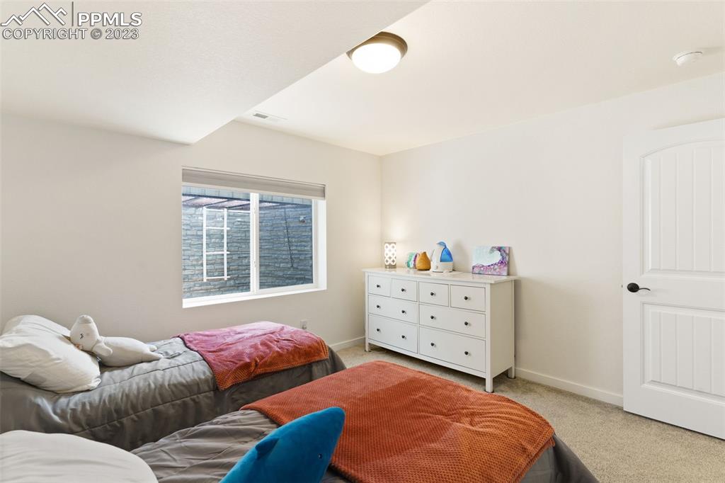 11969 Alydar Loop Colorado Springs, CO 80921 - Photo 24 of 44 a bedroom with furniture and a window