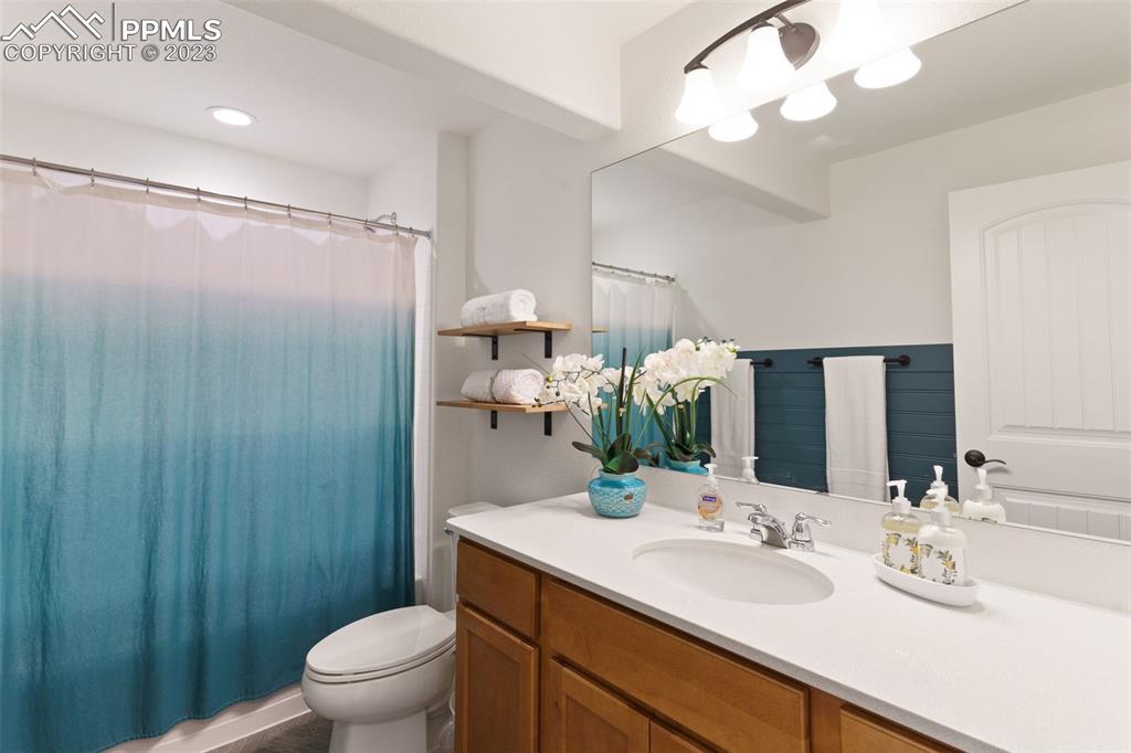 11969 Alydar Loop Colorado Springs, CO 80921 - Photo 34 of 44 a bathroom with a granite countertop sink toilet and shower