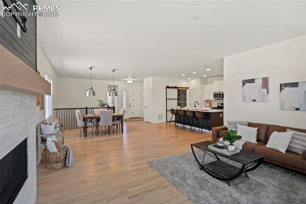 11969 Alydar Loop Colorado Springs, CO 80921 - Photo 8 of 44 a living room with furniture and wooden floor