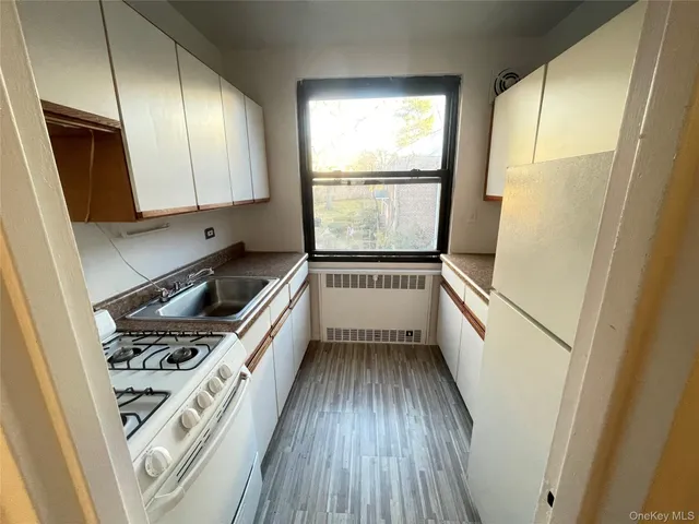 a kitchen with a refrigerator stove and sink