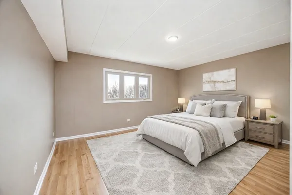 a bedroom with a bed and a night stand