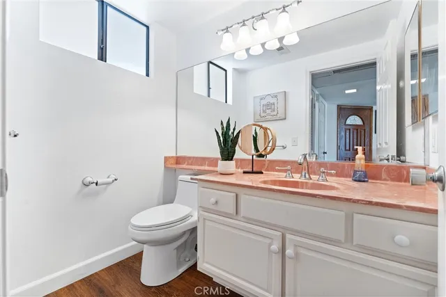 an entryway with wooden floor cabinet and a mirror