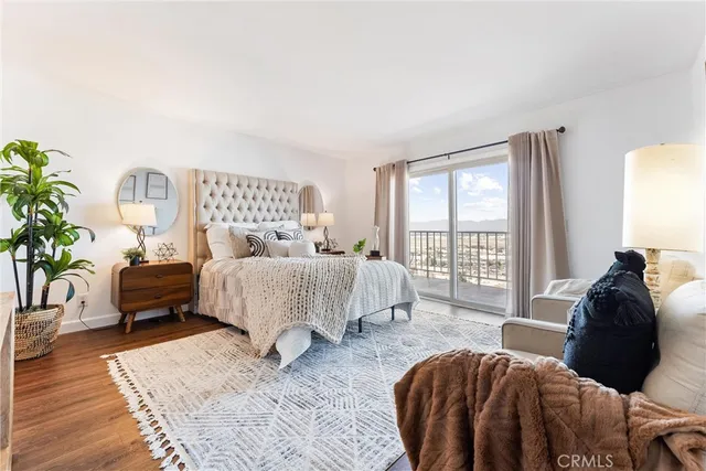 a bedroom with bed and a potted plant