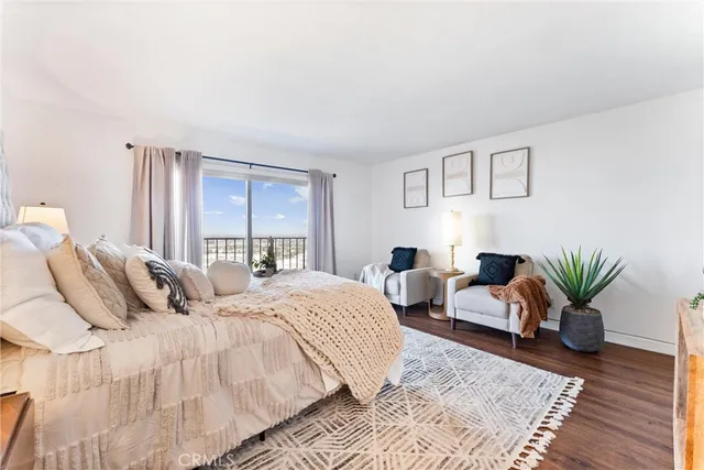 a bedroom with bed a couch and garden view