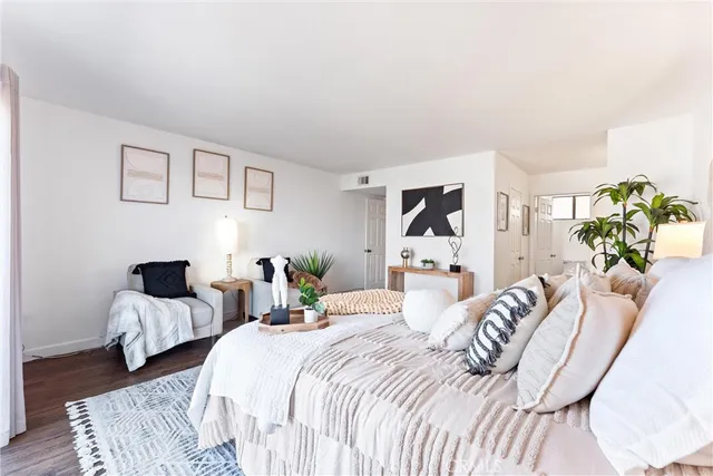 a bathroom with a granite countertop sink a toilet and a mirror