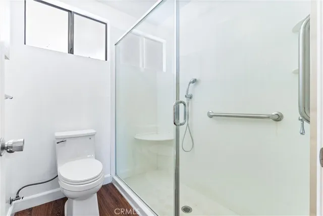 a bedroom with furniture and a shower