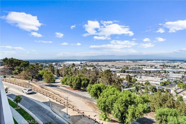 a living room with furniture kitchen view and a window