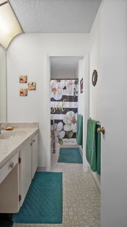 a view of a kitchen with cabinets and wooden floor
