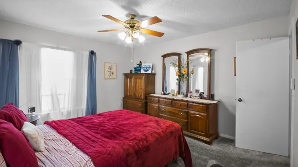 a bed room with a bed and a chandelier