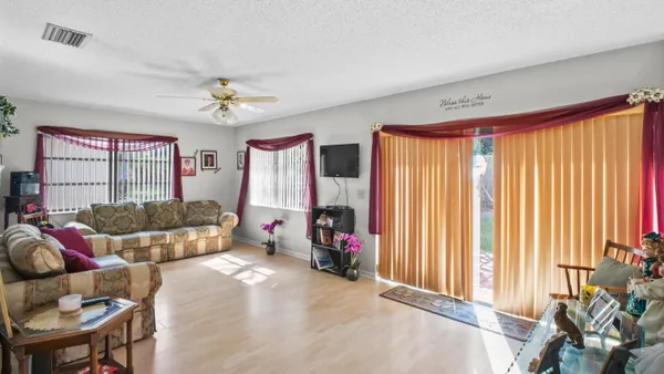 a bedroom with furniture and a large window
