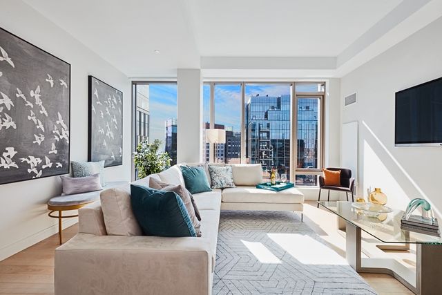 a living room with furniture large window and flat screen tv