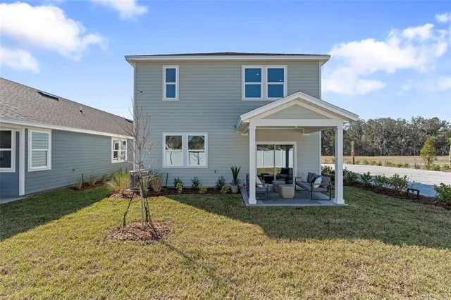 a front view of a house with garden porch and outdoor seating
