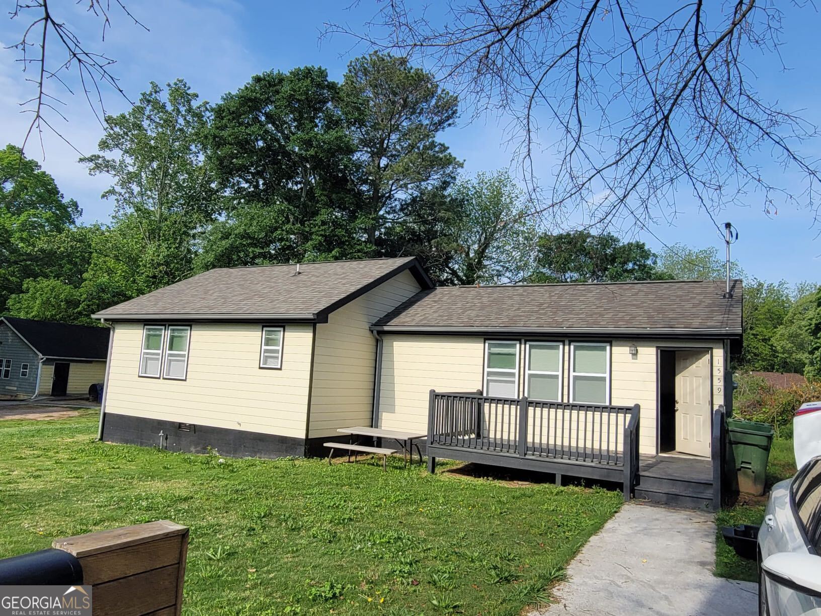 a front view of a house with a garden and deck