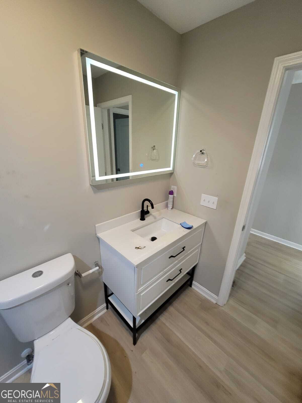 1559 Alma Street Southwest Atlanta, GA 30311 - Photo 6 of 7 a white toilet sitting next to a bathroom sink