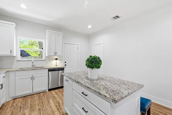 a kitchen with stainless steel appliances granite countertop a sink stove and cabinets