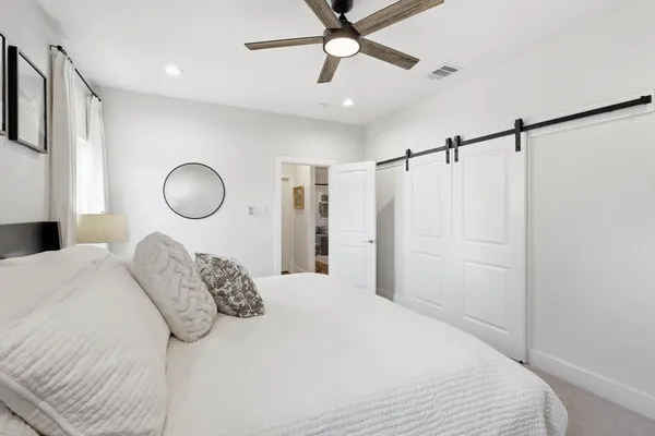 a bedroom with a bed and ceiling fan