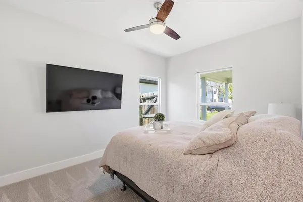 a bedroom with a bed and a flat screen tv