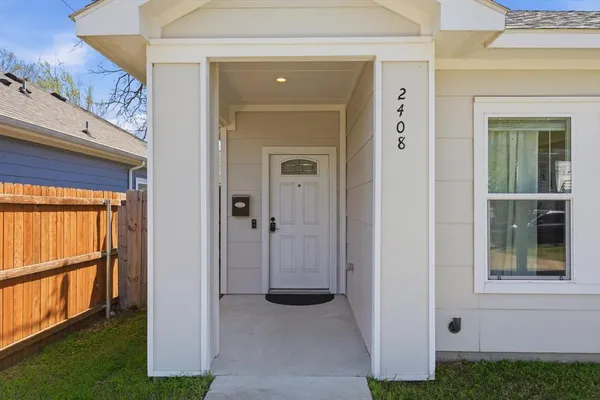 front view of a house with a door and a yard