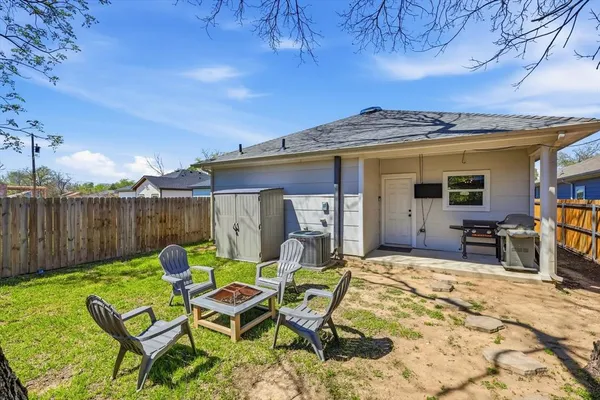 a view of a patio with a dining table and chairs with wooden fence