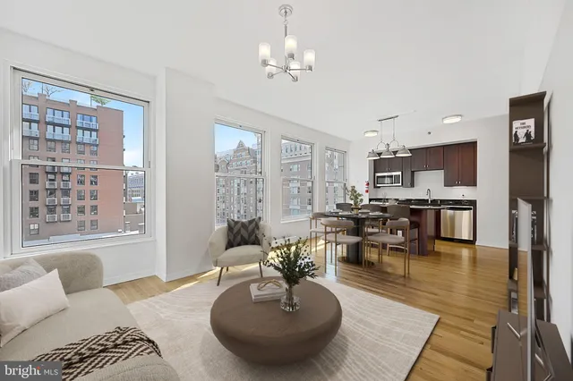 a living room with furniture or couch and a chandelier