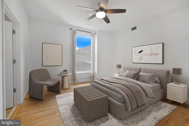 a bedroom with a bed a couch and chair