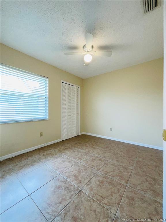 2010 Southwest Beauregard Street Port St. Lucie, FL 34953 - Photo 8 of 10 wooden floor in an empty room with a window