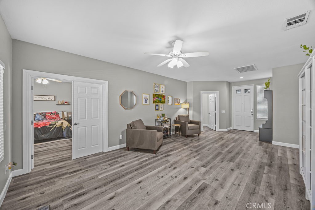 1251 Stepstone Court Hemet, CA 92545 - Photo 19 of 51 a living room with furniture and wooden floor