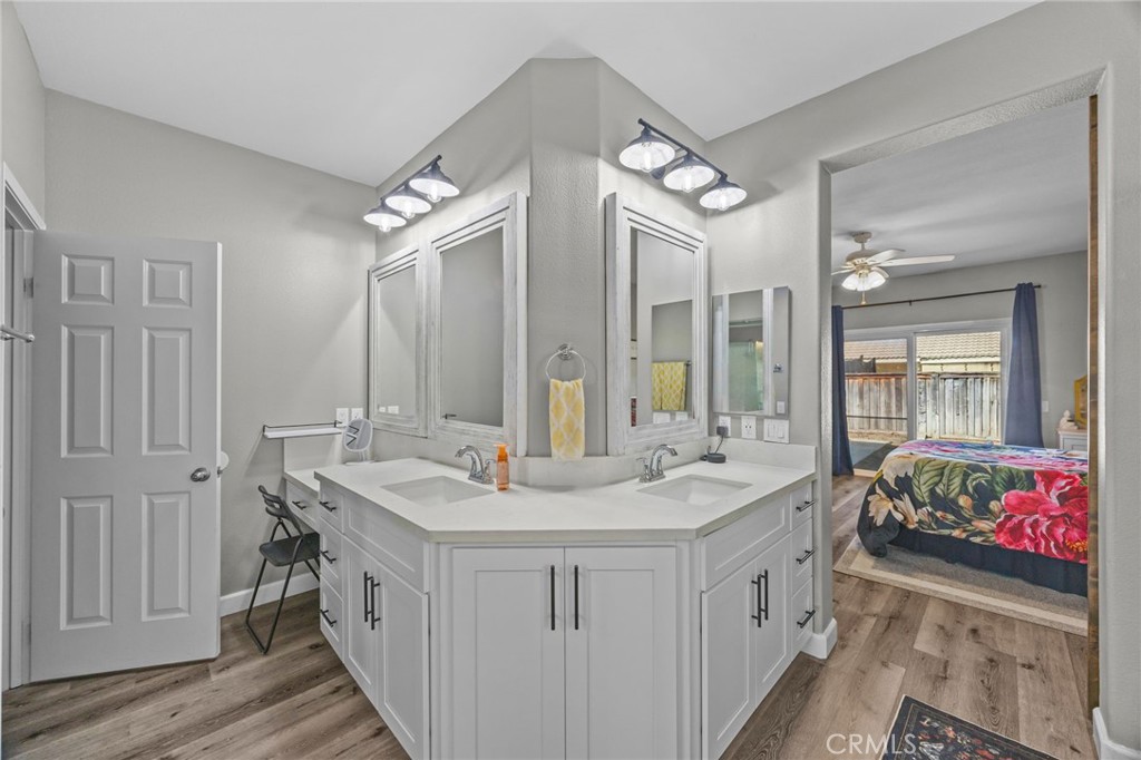 1251 Stepstone Court Hemet, CA 92545 - Photo 24 of 51 a bathroom with a double vanity sink mirror and shower