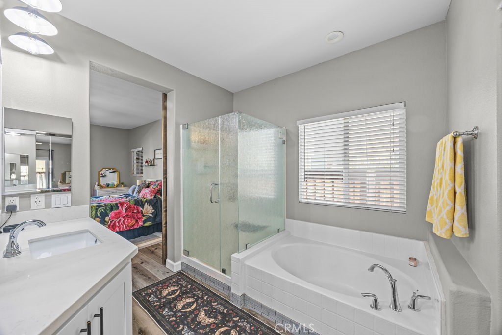 1251 Stepstone Court Hemet, CA 92545 - Photo 25 of 51 a bathroom with a tub sink and mirror
