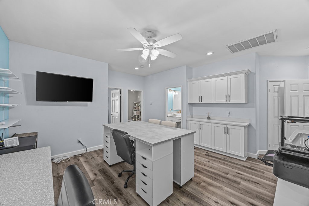 1251 Stepstone Court Hemet, CA 92545 - Photo 26 of 51 a kitchen with a stove microwave and a refrigerator