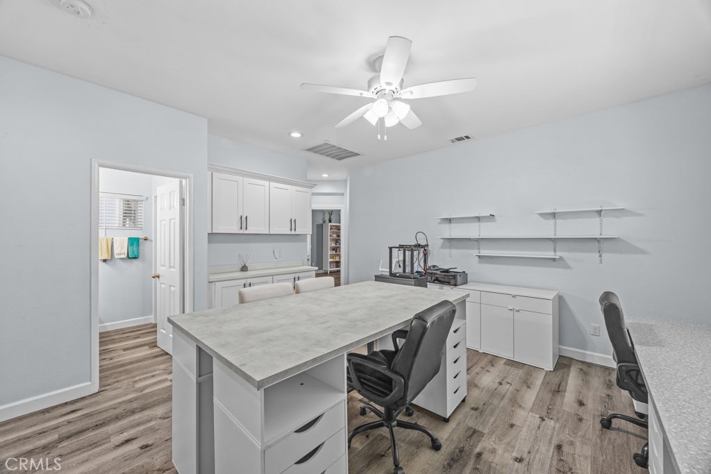 1251 Stepstone Court Hemet, CA 92545 - Photo 28 of 51 a kitchen with a table chairs refrigerator and cabinets