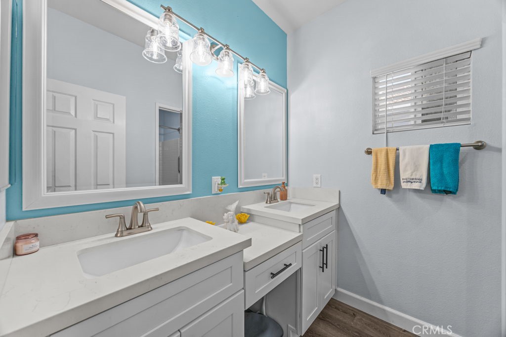 1251 Stepstone Court Hemet, CA 92545 - Photo 29 of 51 a bathroom with a sink and a mirror