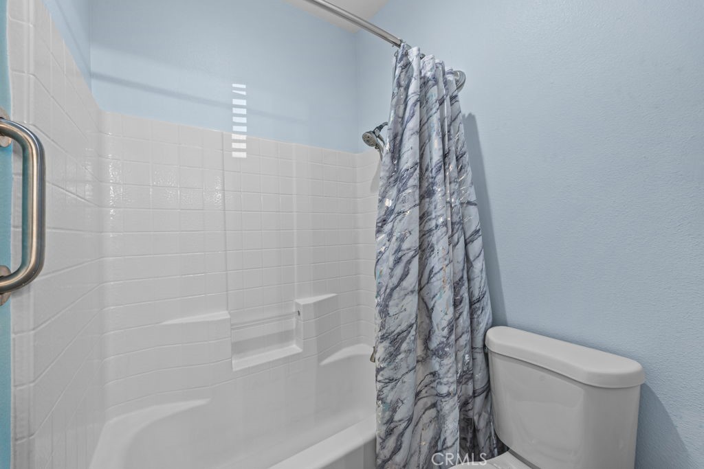 1251 Stepstone Court Hemet, CA 92545 - Photo 30 of 51 a bathroom with a shower a toilet and a shower