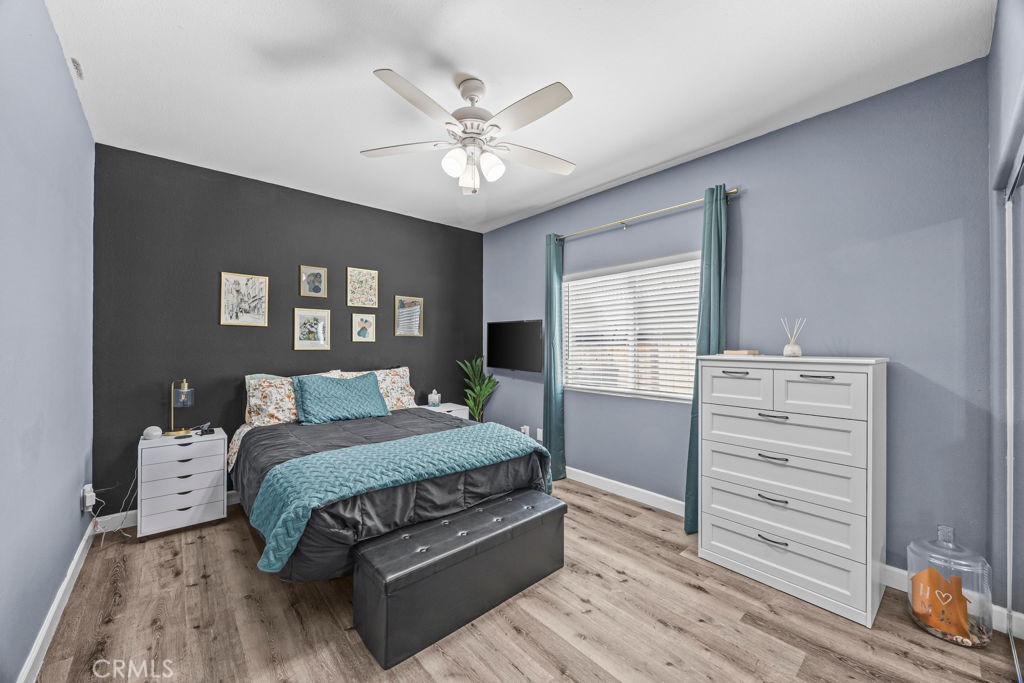 1251 Stepstone Court Hemet, CA 92545 - Photo 33 of 51 a bedroom with a large bed and a chandelier
