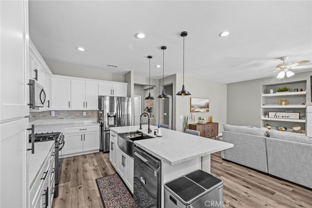 1251 Stepstone Court Hemet, CA 92545 - Photo 8 of 51 a kitchen with a table chairs stove and cabinets